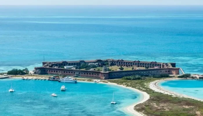 An aerial view of the historic Fort Jefferson surrounded by the stunning turquoise waters of the Dry Tortugas, where charter fishing Key West offers an exceptional experience in this remote and pristine environment.